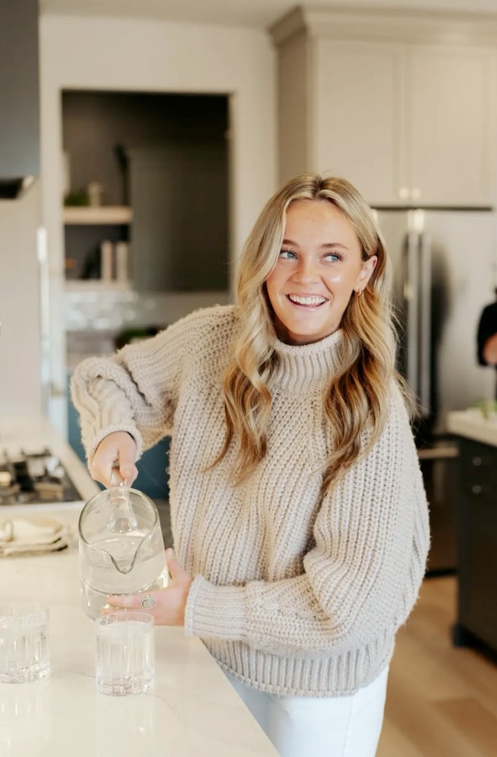 woman pouring a glass of water